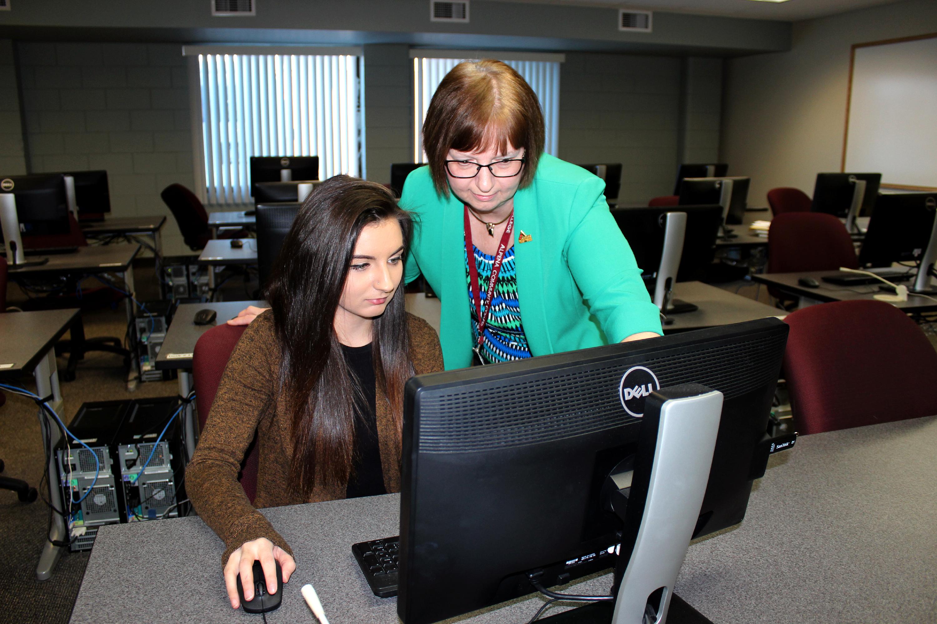 Instructor and student on computer